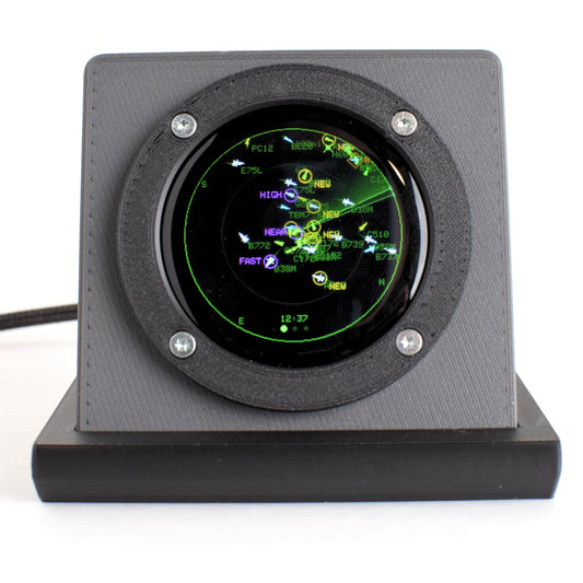 Blipscope live aircraft radar in Nardo grey, rear three-quarter view showing the debossed logo, weighted black base and braided USB cable