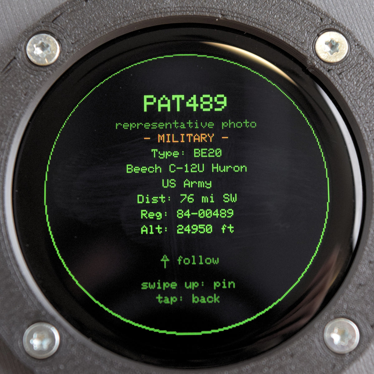 Close-up of the Blipscope round display showing an aircraft photo card with the MILITARY flag for callsign PAT489