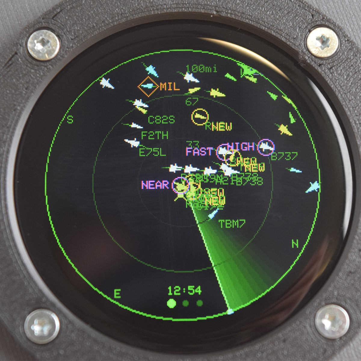 Close-up of the Blipscope 1.28-inch round screen tracking flight WJA1103 between Los Angeles and Vancouver on a map of the western US