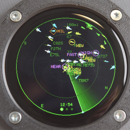Close-up of the Blipscope 1.28-inch round screen tracking flight WJA1103 between Los Angeles and Vancouver on a map of the western US